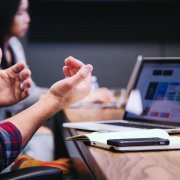 Man in front of computer with smartphone on desk